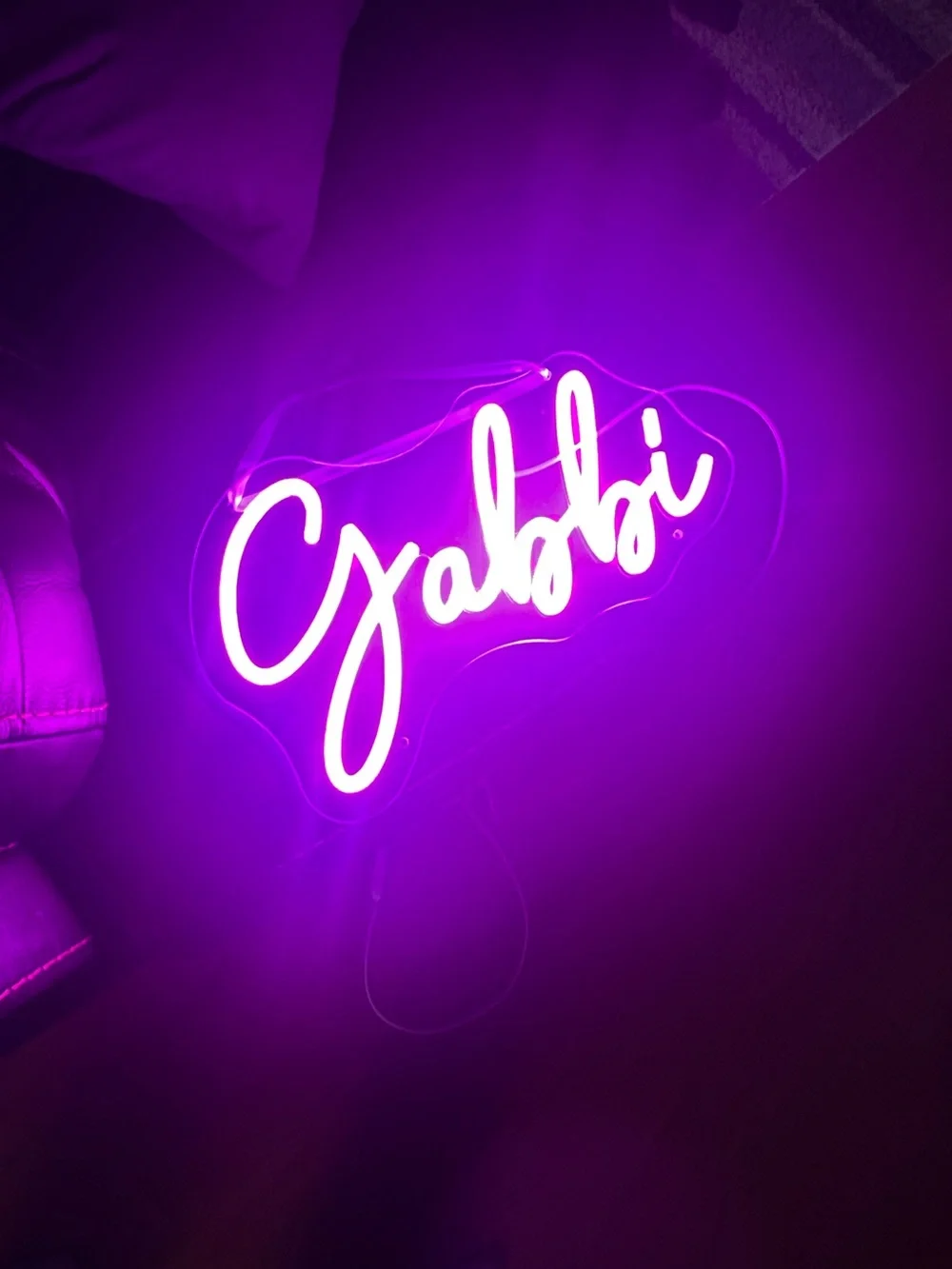 custom Gabbi pink neon-style LED name sign on a clear acrylic backing.